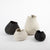 The Gaia vases have a matte finish with a glossed glaze inside. Its unbalanced shape makes for unique curves from all angles. Can be used to display flowers or on its own.  Available in three sizes in black.